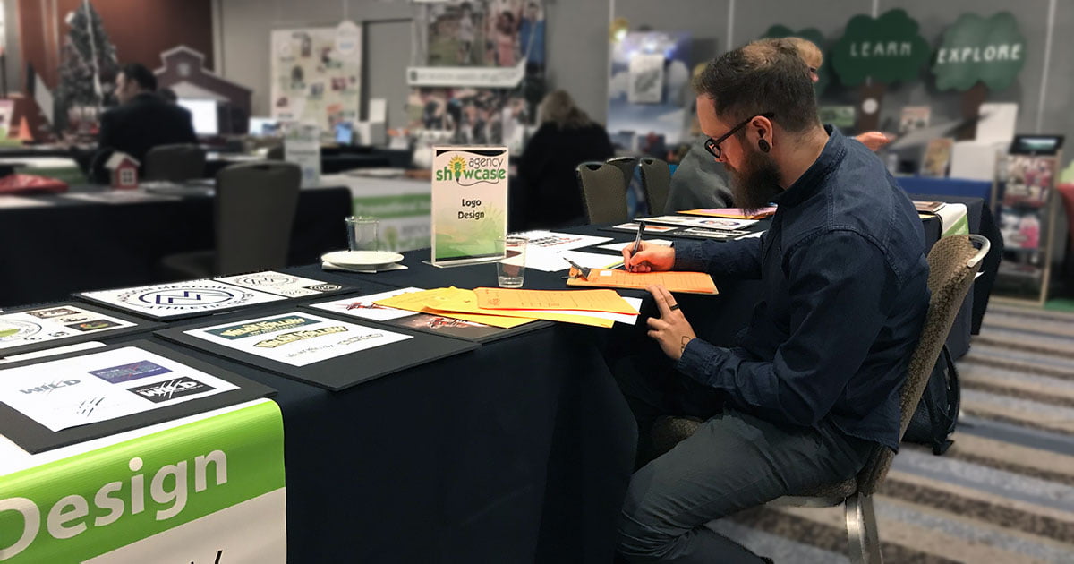 Sean reviewing Park District logo designs